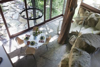 The Remarkable Home of Modernist Designer Russel Wright - Photo 6 of 9 - Wright's dining room and living area opened directly to an outdoor terrace. A massive tree trunk, seen center right, helps support the roof.