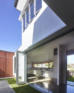 By opening doors and windows on opposite sides of the house and on upper and lower floors, air can easily circulate through this home.
