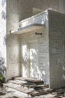 The solid exterior reflects Cadena's concept of a skin, with a strong exterior layer that protects the more delicate, skeletal interior. The hanging bone at the entrance, a piece cast in aluminum, is meant to recall more simple, primitive signage from the past.