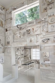 "The pieces told us what they wanted to do on the wall," Cadena says. The menagerie of bones, including pieces from boar, turtles, and even a whale's vertebrae, are deliberately off-white, so it doesn't come across as too pure. The tables and chairs are separated from the walls, so diners aren't too distracted by the details of the elaborate, hand-made murals, which include silverware, serving utensils, and pieces from books.