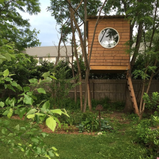 Climb into this snug tree house and watch the world from the inside, through the modern, circular window. 