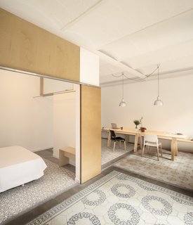 Numerous renovations left the 1930s apartment dark, cramped, and confused, a space searching for a strong personality. Stripping the track-marked wood floors and dropped ceilings of the roughly 750-square-foot space revealed a subtle vaulted ceiling and a colorful series of tiles.