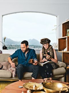 In the living room of their Vancouver home, Omer Arbel and Aileen Bryant sit on a Coronado sofa by Afra and Tobia Scarpa for B&B Italia. They are joined by their Weimaraner, Bowie, boa constrictor, Picasso, and milk snake, Legs.<br><br>"I have a casual approach to prototyping that involves our day-to-day life. I am always tinkering, and I have lots of transformers to run electricity through things, but Aileen lives with me now, so I have to be respectful. Before she moved in it was like a total madhouse; now I can’t pour concrete in the kitchen. It is a collaboration in a sentimental sense. This work is my life, and the objects are my objects, but how they are arranged and the flow of each room are something we’ve created together here."