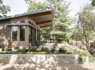 To install Charles Willson’s prefab house, Stillwater Dwellings lifted the structure over an existing barn on the one-acre property. Willson, who is often on the road, wired the house with the latest in smart technology.