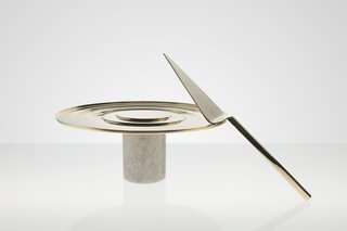 Stone Cake Stand, $180<br><br>This Cake Stand from Tom Dixon will take your friend’s artful dessert displays to the next level. A substantial white Morwad marble base supports a ribbed brass plate that is finished with a warm gold wash and adorned with a neat circumferential lip to enhance the perfect presentation.
