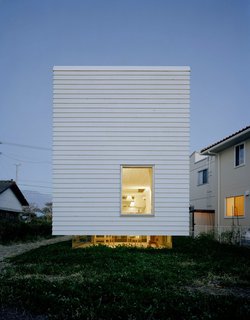 8 Distinct Ways of Living in Japan - Photo 1 of 8 - The distance between site and structure is more dramatic in the evening when light shines through the sunken glass living room.