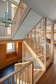 The American Yellow Birch-clad staircase was designed as a screen inspired by light filtering through a forest.<br><br>Photo by: Eric Hausman Photography
