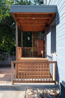 A cedar deck and beams create the transition to the back entry.<br><br>Photo by: Eric Hausman Photography