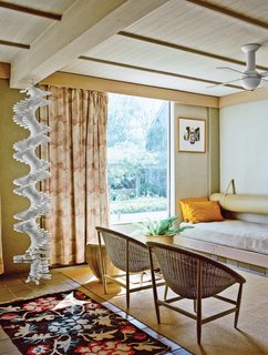 The ground-floor guest room sports built-in beds and a hanging sculpture by Robert Clark.