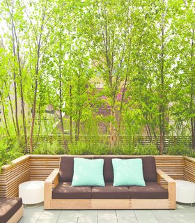 A sofa from Sutherland’s Poolside collection is covered in fabric from Perennials; the illuminated side tables are by Porcuatro for Tango Lighting. The screens are constructed from FSC-certified teak.