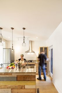 Stainless steel was selected for the kitchen countertops, and the pair relied on a local industrial sheet metal fabricator to help them prepare the material for residential application. The mix of warm and cool adds depth and dimension to the space.