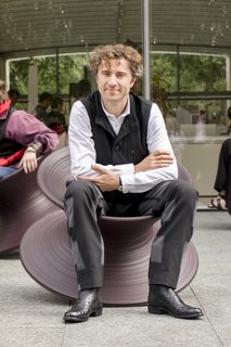 Thomas Heatherwick seated in the Spun chair he designed in 2010. Made from rotational moulded polyethylene, it's designed by a single profile rotated 360 degrees around an axis.