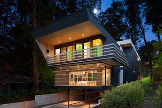 The house was shaped by spatial restrictions. 'The angled walls push the interior spaces outward both visually and as experienced,' says Svenson. 'The horizontal lines of the railings and screen porches add to that. To increase this perception the angled walls occur only in areas suspended in the air—they are never tied to the ground.<br>The architect carved out a parking and storage area underneath the residence. 'The house feels as though it floats above the ground plane,' he says.
