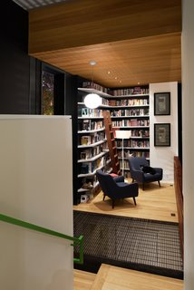 Due to zoning restrictions, the house's footprint had to be relatively small, so Svensen devised a solution: split levels. The library occupies a landing on the staircase and features shelves built by Atlanta's Dark Horse Woodwork.