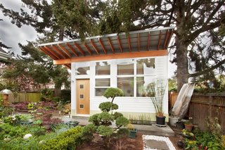 A Tiny Backyard Studio in Seattle Filled With Midcentury Finds - Photo 2 of 8 - Working with a limited budget, First Lamp designed and built one principle architectural flourish: exposed Douglas fir rafters that would weather to a brighter red over the years and accent the white siding.