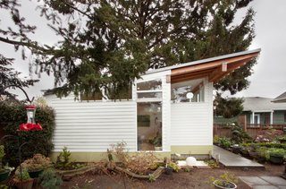 A Tiny Backyard Studio in Seattle Filled With Midcentury Finds - Photo 3 of 8 - Exposed Douglas fir is usually prohibitively expensive in larger projects but was far more economical in this case: First Lamp could stain the wood themselves in one afternoon, obviating the need for subcontractors. Another small but impactful detail was the tapering cut of the rafters which gives the studio a more dramatic profile.