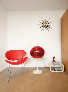 A Tiny Backyard Studio in Seattle Filled With Midcentury Finds - Photo 7 of 8 - The floor is polished concrete, chosen for its durability, low-cost, and minimal maintenance. The red fiberglass armchair is from Modernica.