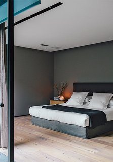 A Lush Retreat With a Sheltered Rooftop Pool in Mexico City - Photo 9 of 14 - The master bedroom, painted in Whisper by Comex, sports a bed that Farca custom-designed as part of his EF Collection.