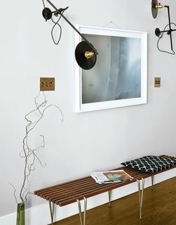 Workstead wall-mounted lamps illuminate a photo from Cloud Series by Matthew Williams. The bench is by Hugh Acton. 