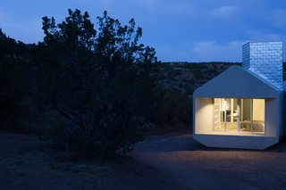 The Element House stands on pylons, creating the illusion of it hovering over the desert floor. Nine thermal chimneys, one of which can be seen right, channel hot air out from the interior living areas.