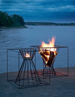 The Boo Fire Basket from Skargaarden is made of black lacquered steel. Designed to fit several logs for an outdoor fire, the Boo can also be overturned to hold a candle or lantern.