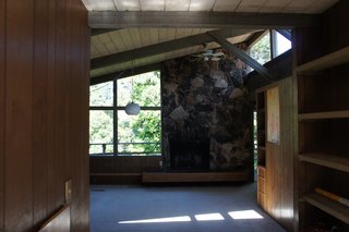 Bright Renovation of a 1970s Big Sur Home - Photo 3 of 10 - Before<br><br>In the original east-facing living room, the light was partially blocked by a poorly located fireplace.