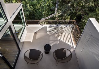 Bright Renovation of a 1970s Big Sur Home - Photo 10 of 10 - "When you have a tiny house, having outdoor spaces off a room can make a big difference," Schicketanz says. Luckily, each room already had its own deck, which the architect simply refurbished by installing concrete floors and galvanized stainless steel railings.