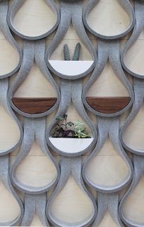 The Felt Droplet system by Garman Furniture consists of strips of natural wool felt that are capable of supporting a two-inch-deep shelf or planter.