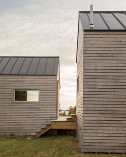 A Cluster of Cabins in a Former Quarry Makes a Simple Vacation Escape - Photo 9 of 13 - Sited parallel to each other, the two autonomous bedroom cabins frame perspectival views of the surrounding landscape. Exteriors of all three structures feature mitered corners and cross-laminated timber panels, all nailed by hand.
