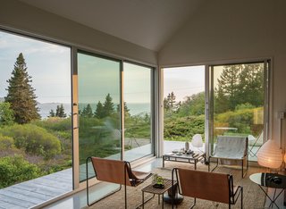 A Cluster of Cabins in a Former Quarry Makes a Simple Vacation Escape - Photo 4 of 13 - Two smaller, adjacent structures house autonomous bedrooms, each equipped with a full bathroom.