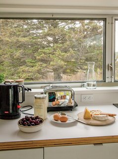 A Cluster of Cabins in a Former Quarry Makes a Simple Vacation Escape - Photo 8 of 13 - The room is outfitted with IKEA cabinets, an oven by Miele and a cooktop by Gaggenau.