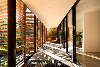 In a Miami residence designed by Melissa and Jacob Brillhart, horizontal louvers on exterior shutters filter daylight while still creating a shaded indoor/outdoor area.