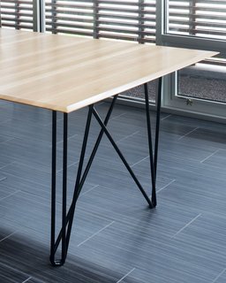 Reclaimed wood is a recurring feature of Hufft's furniture. The Wright Wing dining table is pictured.