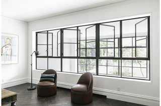 "We did a lot of studies for the project to show how we could get huge amounts of light into the rear of the house," Roberts said, which culminates in the two-story addition that replaced the original collapsing wall. The living room’s two antique round leather chairs, by Ralph Lauren, are within view of the garden beyond matching sets of windows.