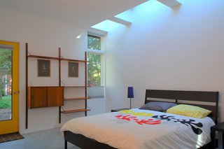 In the bedroom, an IKEA bed frame and CADO wall unit are drenched with natural light during the day from the skylights overhead. "The effect of daylight through skylights is very different than from a window," Hart says. "You feel every minute of the day as light in the space ebbs and flows with the passing clouds."