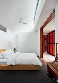 A wardrobe from IKEA and a bed by Rye Dunsmuir outfit one of two bedrooms.