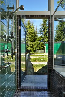 This Retreat in the Cascades is a Bold Take on the Modern Cabin - Photo 3 of 10 - "I wanted the bathtub and shower to be at the foot of the terrace, so one could look out and feel the connection to the site," Coleman said. "French roast," an unglazed porcelain tile by American Olean, covers the shower.