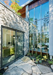 A Tranquil Lakeside Abode in Quebec Unfolds Over Six Levels - Photo 2 of 9 - While the homeowners and their guests have plenty of opportunities to view the outdoors, thanks in large part to windows and doors by Alumilex, an abundance of cedars offers privacy from the outside looking in. "We wanted to cut the least amount of trees," Tremblay said.