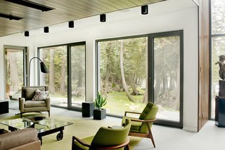 A Tranquil Lakeside Abode in Quebec Unfolds Over Six Levels - Photo 4 of 9 - Low-impact materials were also used for the interior design, which is comprised primarily of concrete, glass, stone, wood, and steel. A palette of mostly light and neutral shades puts the attention on the views.