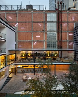 Today, as in the 1970s, the central courtyard is an oasis within the city. The hollow concrete blocks provide an industrial edge and add an element of texture to the poured-in-place concrete and red brick of the other facades of the courtyard.