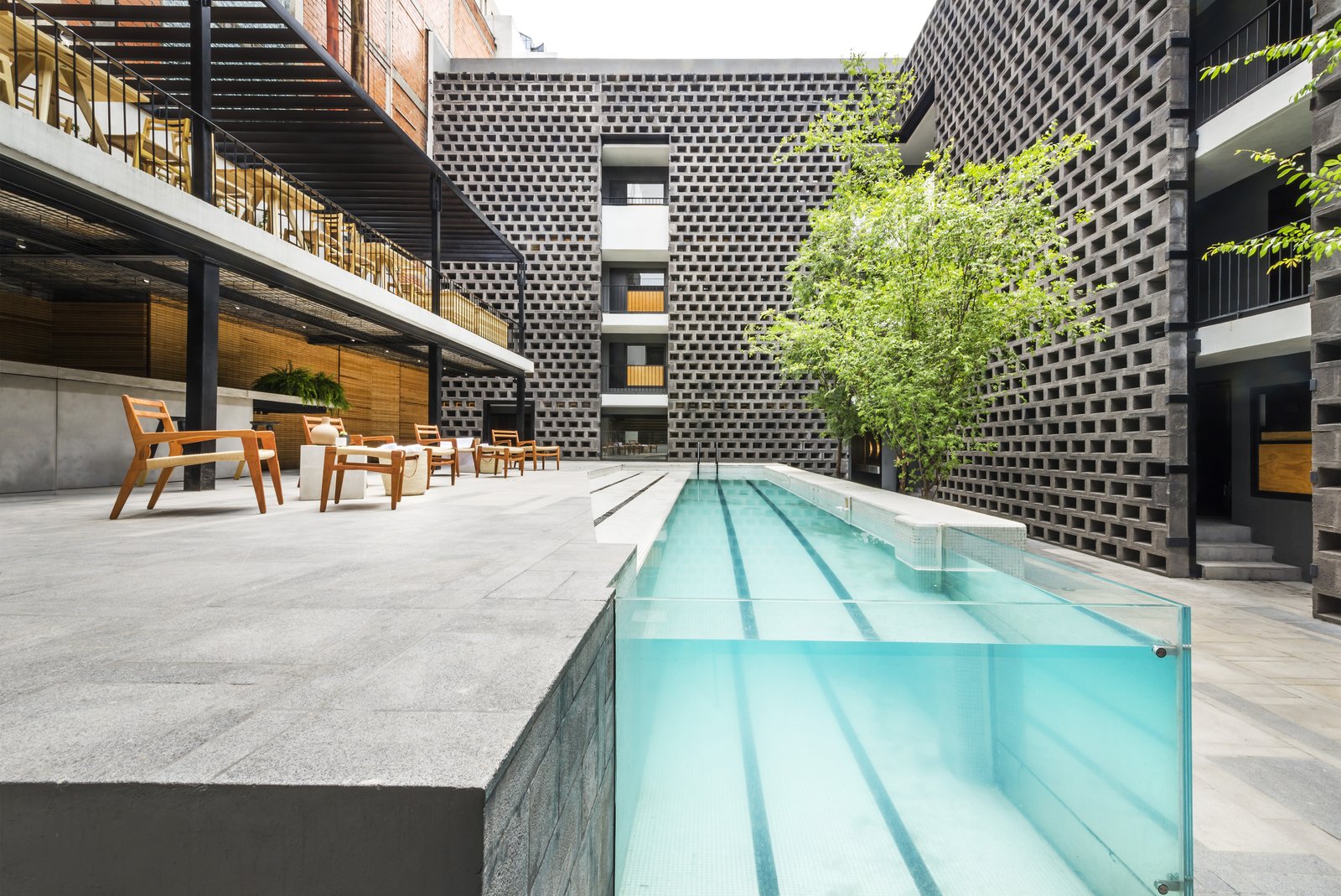 A pool is still the focal point of the courtyard, but its modernized, streamlined design makes a dramatic statement.