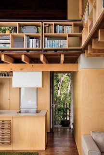 A Home's High Ceilings Are Responsible for Some Impressive Views - Photo 2 of 10 - Architect and resident Andrew Simpson maximized the diminutive home with double-height ceilings, elevated compact shelving, and lofted sleeping quarters.