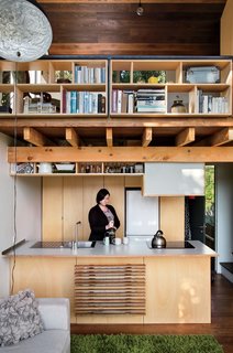 A Home's High Ceilings Are Responsible for Some Impressive Views - Photo 8 of 10 - On the ground floor, Simpson’s fiancée, Krysty Peebles, makes coffee in a compact kitchen outfitted with a Foraze Panni sink, Bosch induction cooktop, and Mitsubishi refrigerator.