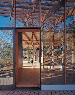See-through dividers in the form of open bookshelves define the interior public spaces; the fiberboard planks are by Hokushin.