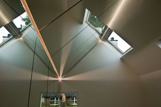 Danish Farmhouse Turned Contemporary Art Studio - Photo 4 of 6 - Because of the mirrored interior, the VELUX Group placed the roof windows towards the northeast in an effort to minimize any direct light, and hence uncomfortable heat, within the studio.