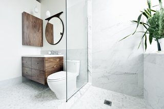"What could I have that would feel luxurious, would make me feel really great?" muses one of the homeowners. "My husband and I travel a lot in Europe, and we always loved the marble showers. So we put a marble shower up against the window." The sink and countertop are from Batimat, while the wall-hung vanity is another custom piece by Gepetto.