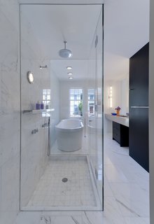 Italian Calacatta Gold marble tiles in the bathroom match an equally pristine Duravit bathtub. Vola fittings were installed in the shower.