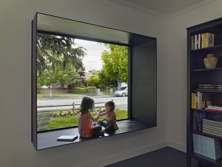 An Indoor-Outdoor Renovation for a 1950s Ranch House in the Bay Area - Photo 5 of 8 - The original home was preserved and renovated. In the front bedroom, a small window was replaced with a large painted-steel window seat, a favorite of the residents' grandchildren.