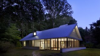 The home is clad in galvalume, a low-maintenance, zinc-coated metal, to make upkeep easier. Prefabricated, 10- to 12-inch-thick panels in the roof provide insulation, and the low walls are packed with limestone.