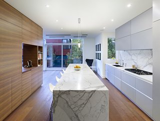 "The walnut unit between the kitchen and dining room ties into the fumed oak floor," Dubbeldam says. "The rest of the materials in the house—glass, marble, stone—were selected to offset the wood."